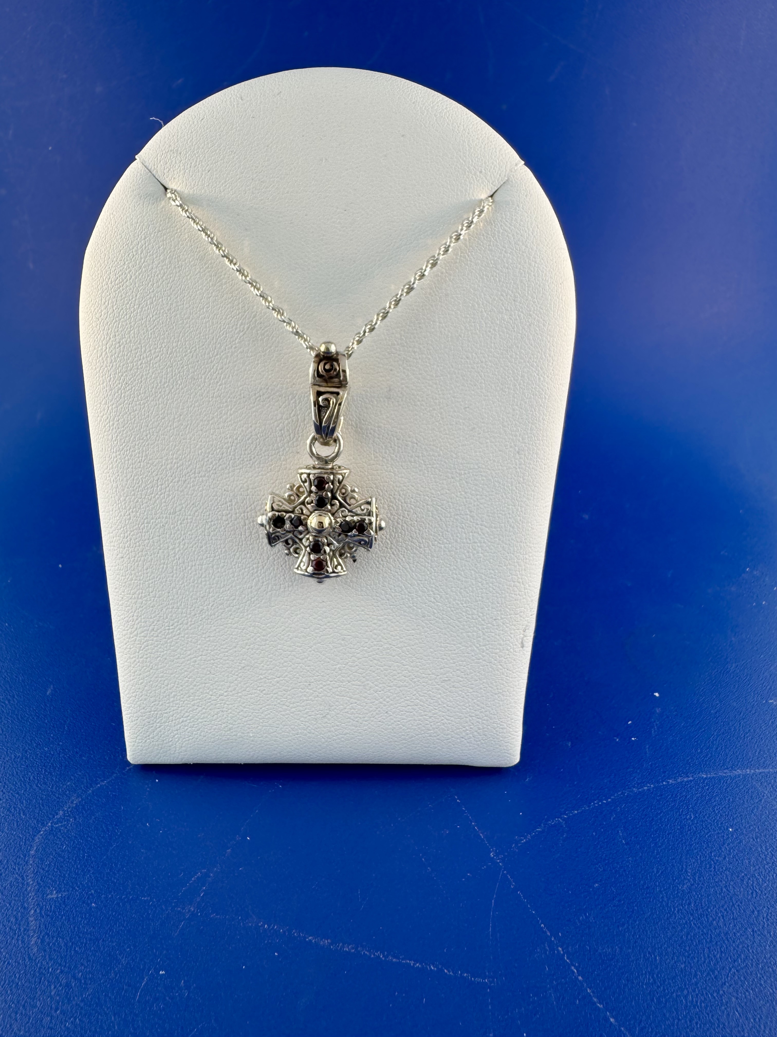 Sterling silver and 18 kt garnet cross pendanr